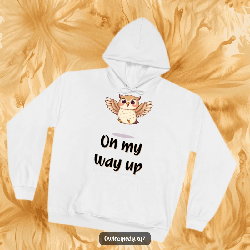 Funny hoodie featuring a small owl enthusiastically flapping its wings mid-jump, offering warmth and humor for active spirits.
