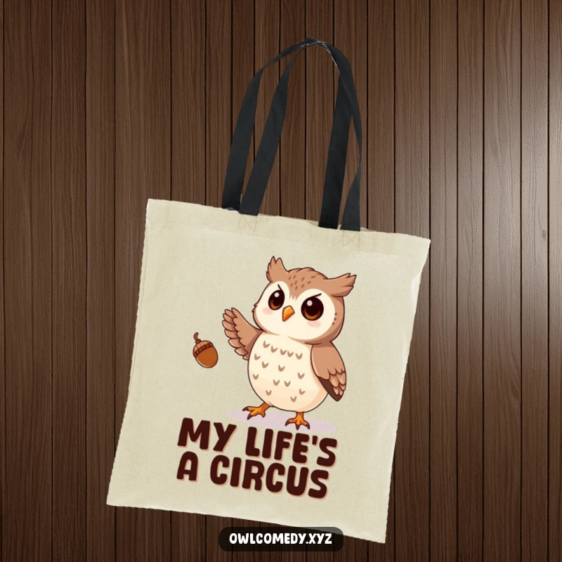 Funny tote bag with a playful owl artistically juggling small acorns using its talons, a whimsical carry-all.